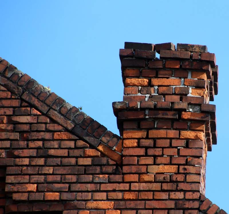 Signs Your Watauga Home Needs a Chimney Inspection Blog Article - Damaged chimney on an Watauga home showing cracks and missing mortar